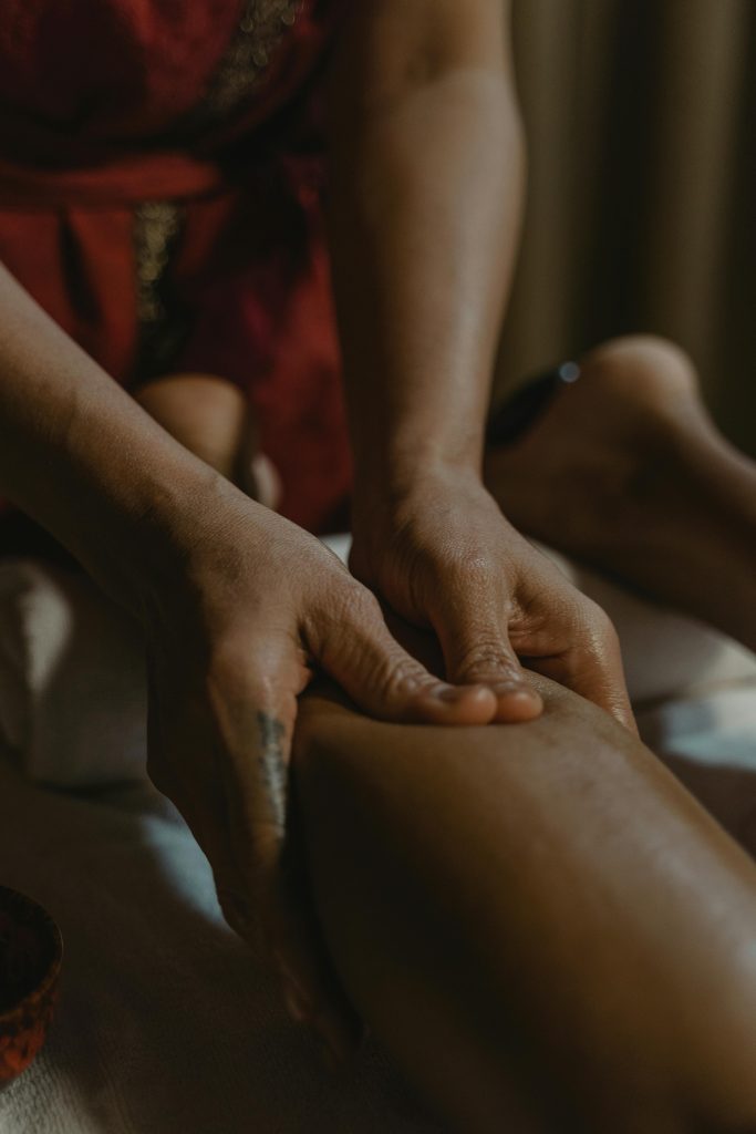 Deep Tissue and Sports Massage in Glasgow, Scotland. This image shows a lady massaging a calf muscle. 